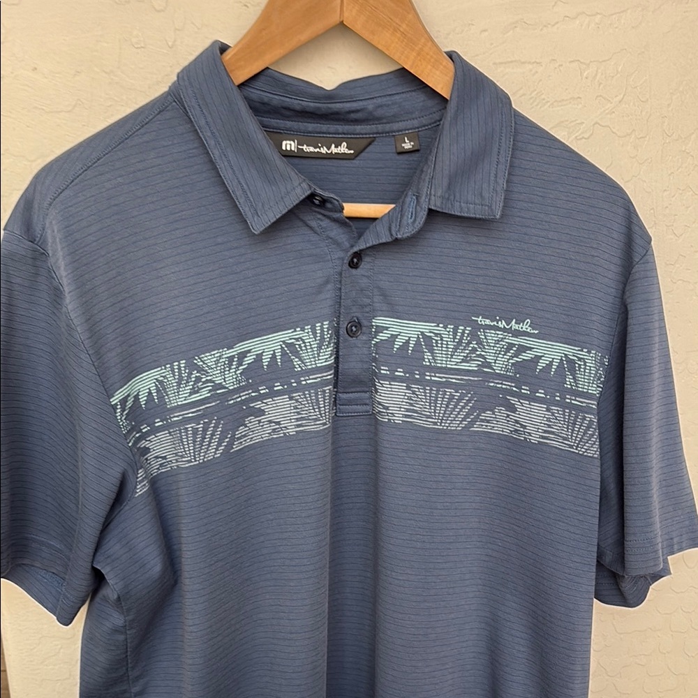 Travis Mathew Blue Polo Shirt with Palm Leaf Pattern